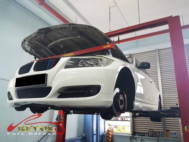 BMW 3 Series on hoist for inspection at Revol Carz Garage