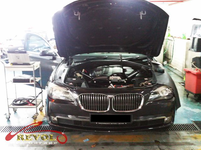 BMW 5 Series engine bay during repair at Revol Carz Garage