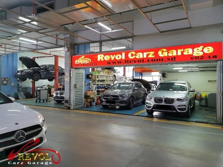 Revol Carz Garage mechanic running diagnostic on a BMW engine