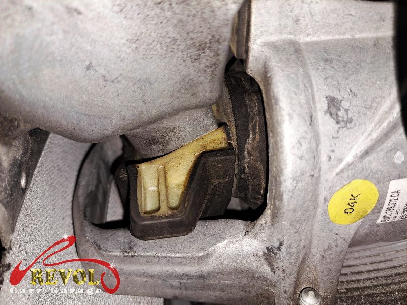 The transmission mount removed showing the play under load.