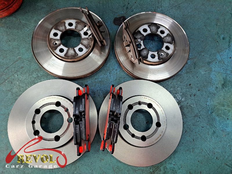 The old discs removed alongside the new genuine set.