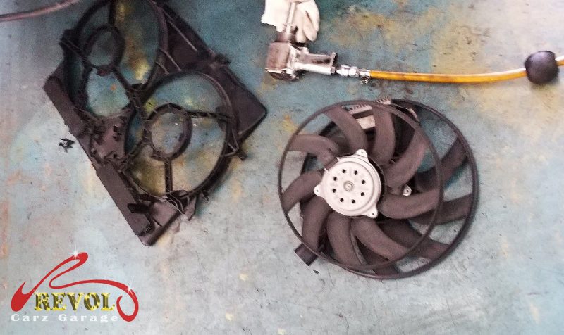 The old failed radiator fan assembly removed.