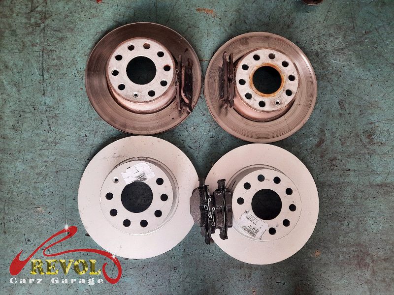 The old discs removed alongside the new genuine set.