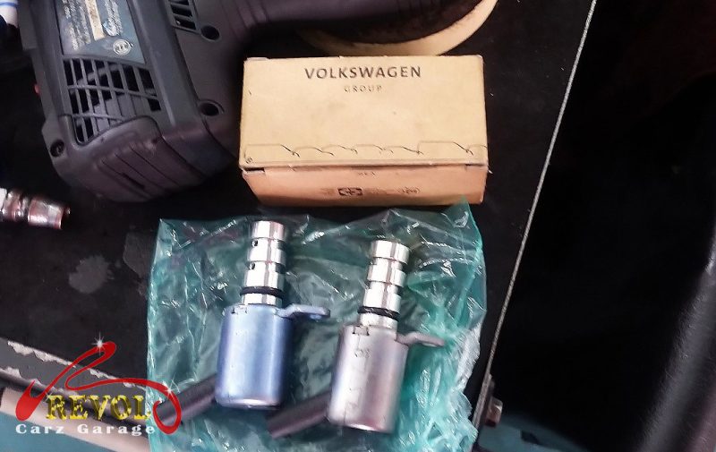The old oil separator and valve removed from the engine.