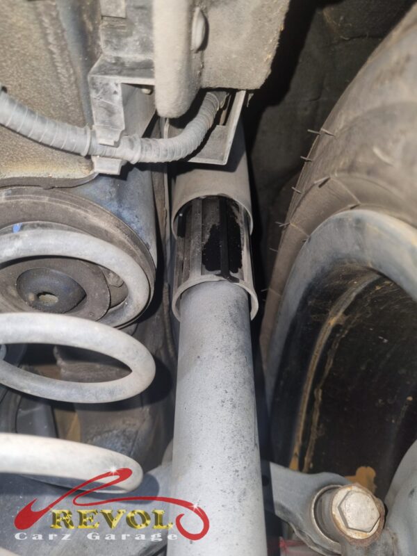 The old rear shocks removed beside the new Audi-spec pair.