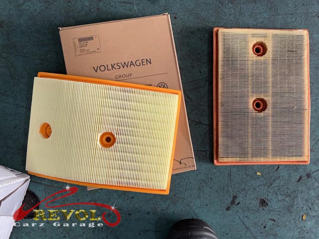 The old air filter beside the new VAG-spec replacement.
