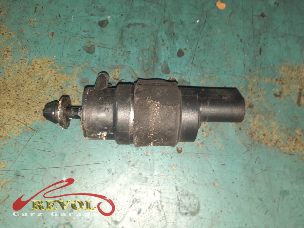 The old washer pump removed from the base of the reservoir.