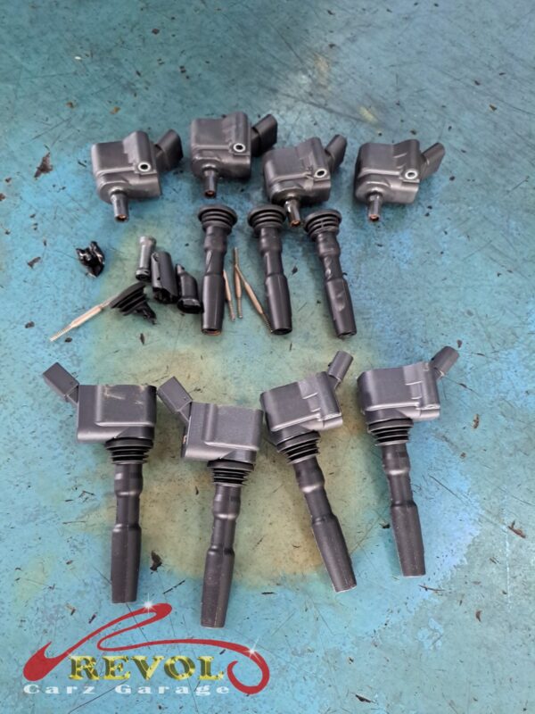 The old worn spark plugs removed from the engine.