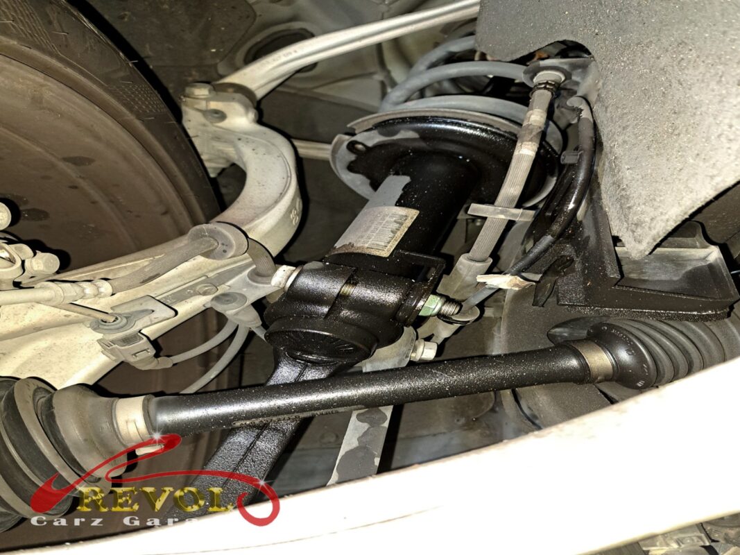 The old shocks removed beside the new Audi-spec set.