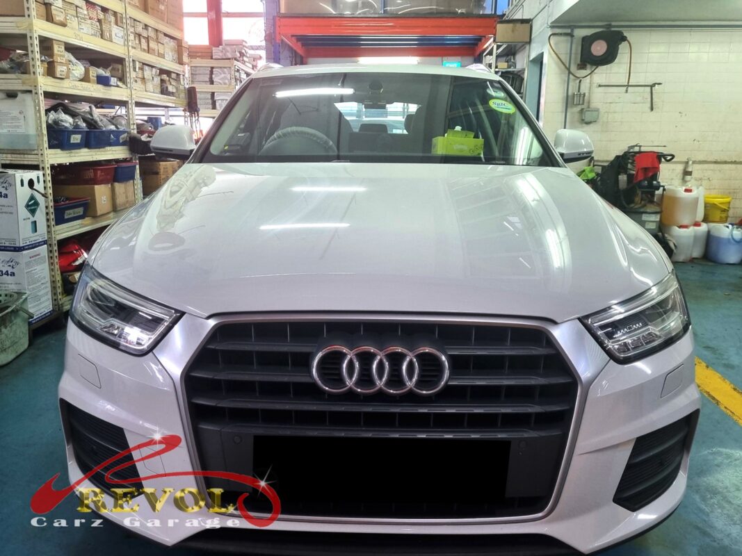 Audi Q3 parked at the workshop, in for front lower arm inspection.