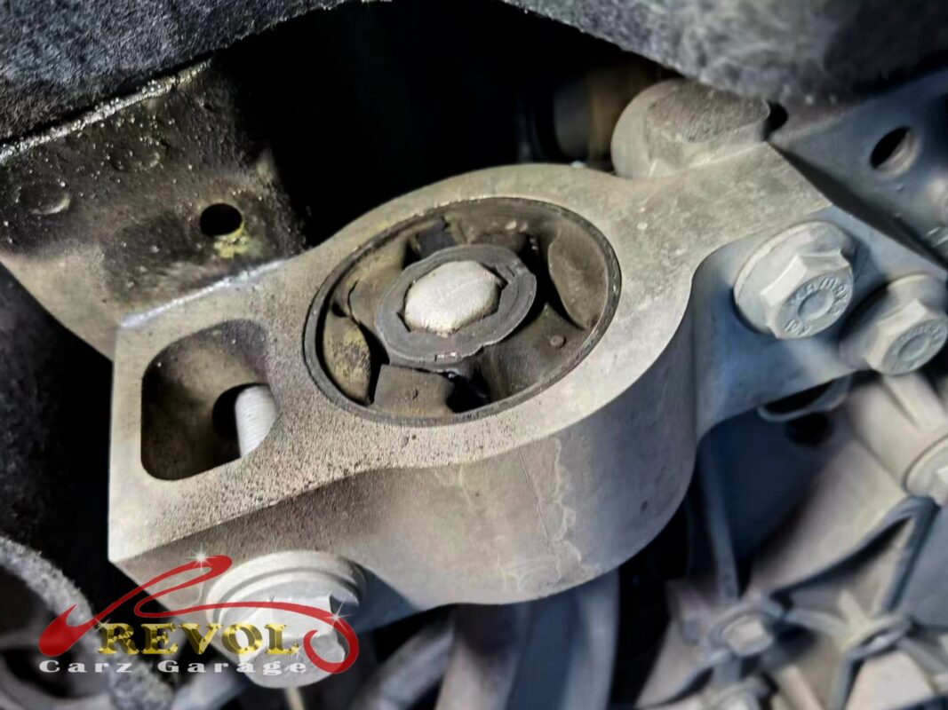 The old front lower arms removed beside the new Audi-spec pair.