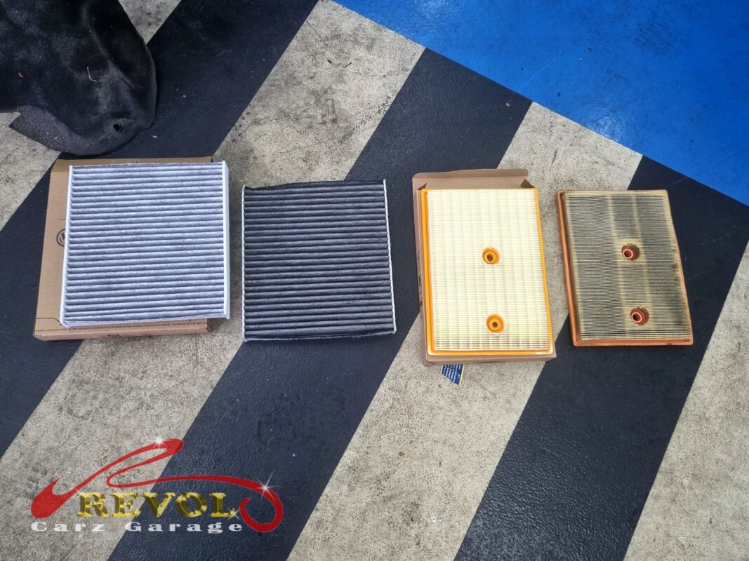 The old air filter beside the new VAG-spec replacement.
