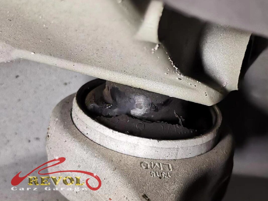 The worn front upper arm bush on the Audi A4.