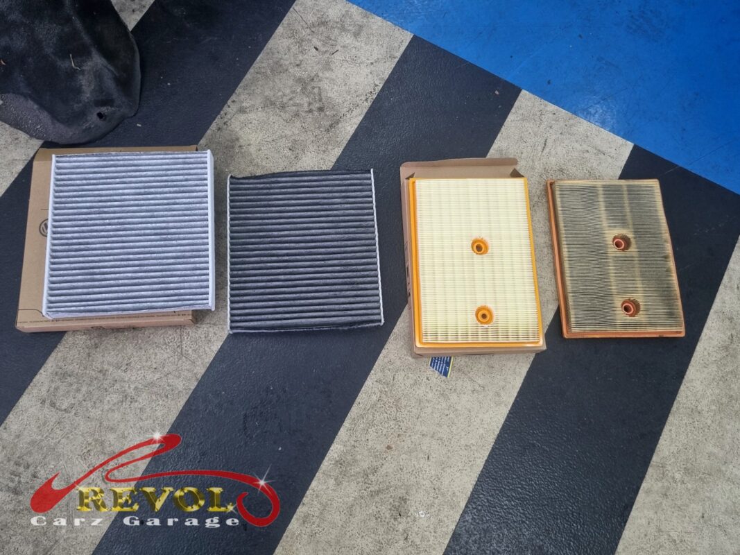 The old air filter beside the new VAG-spec replacement.