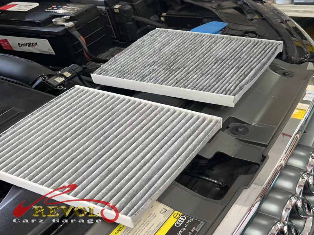 The old air filter beside the new VAG-spec replacement.