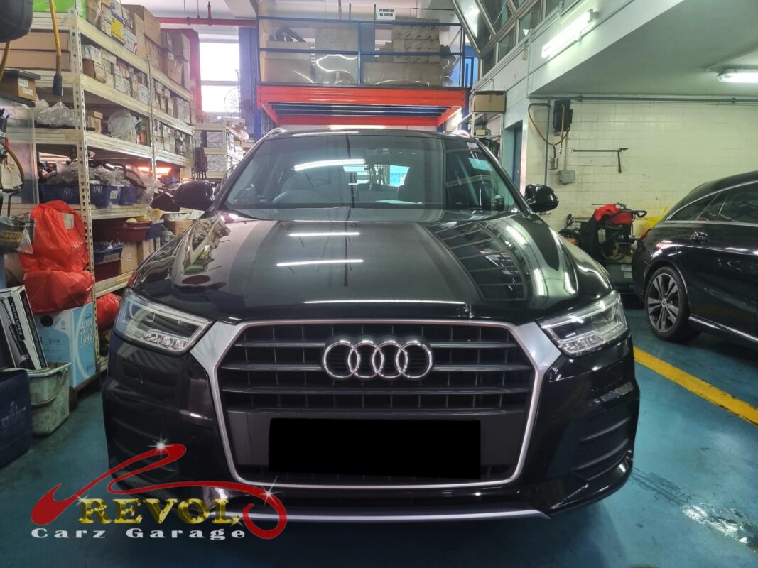 Audi Q3 in the workshop for coil and spark plug replacement.