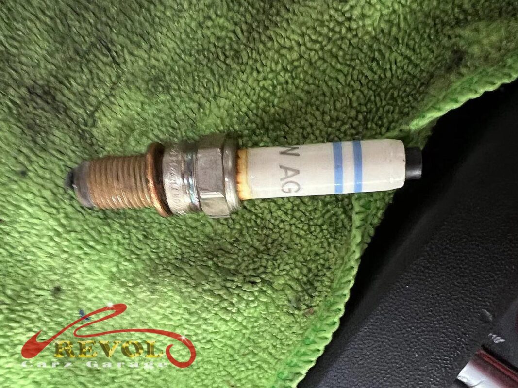 Failed ignition coil identified by swap-test laid out next to the new one.