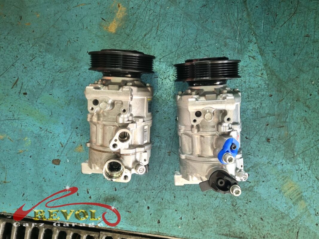 Failed AC compressor removed, worn bearings visible.
