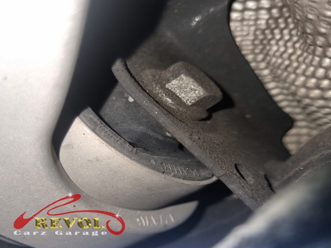 Old lower control arm removed, bushing cracks visible.