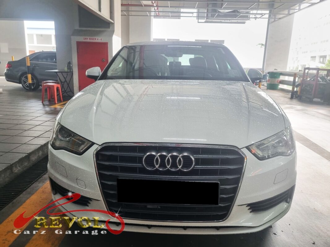 Audi A3 on the workshop lift with the front wheel off for bearing replacement.