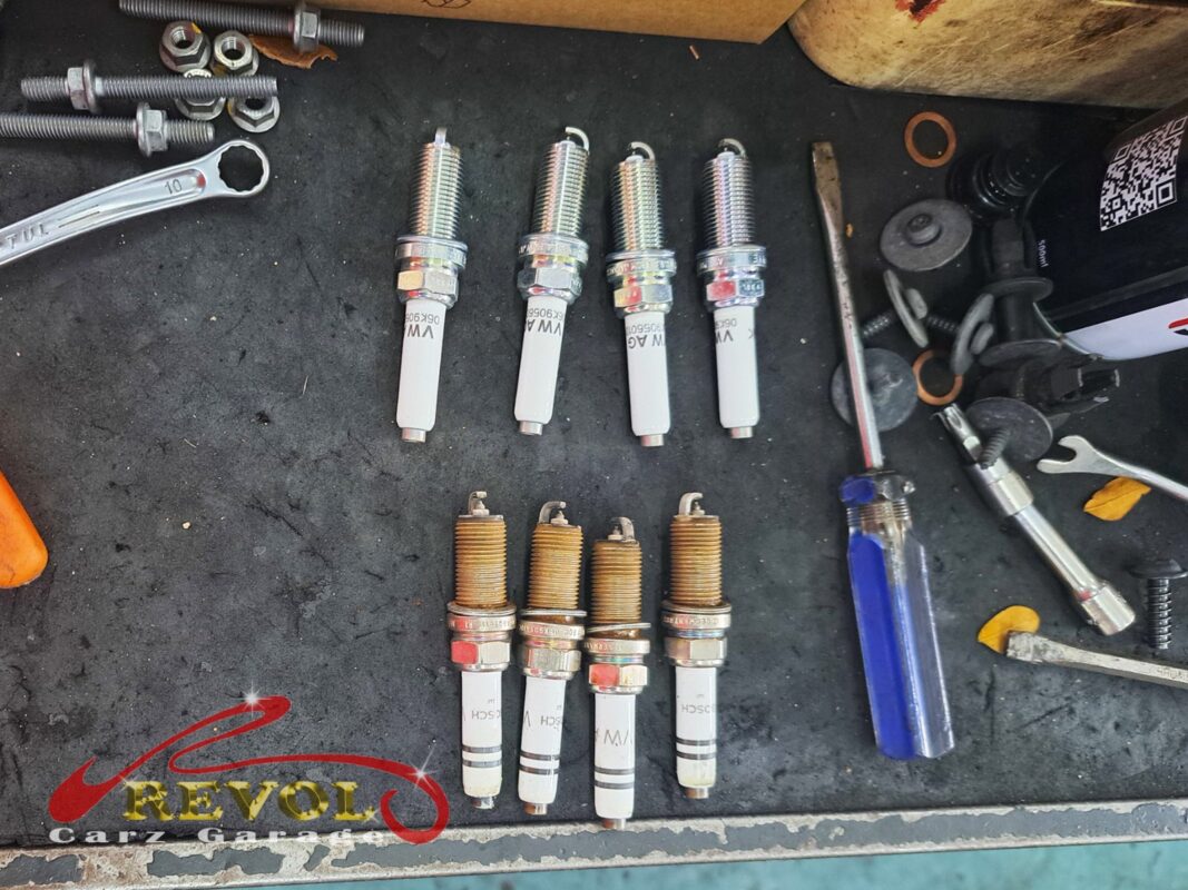 Old ignition coils on the bench, high-resistance ones flagged.