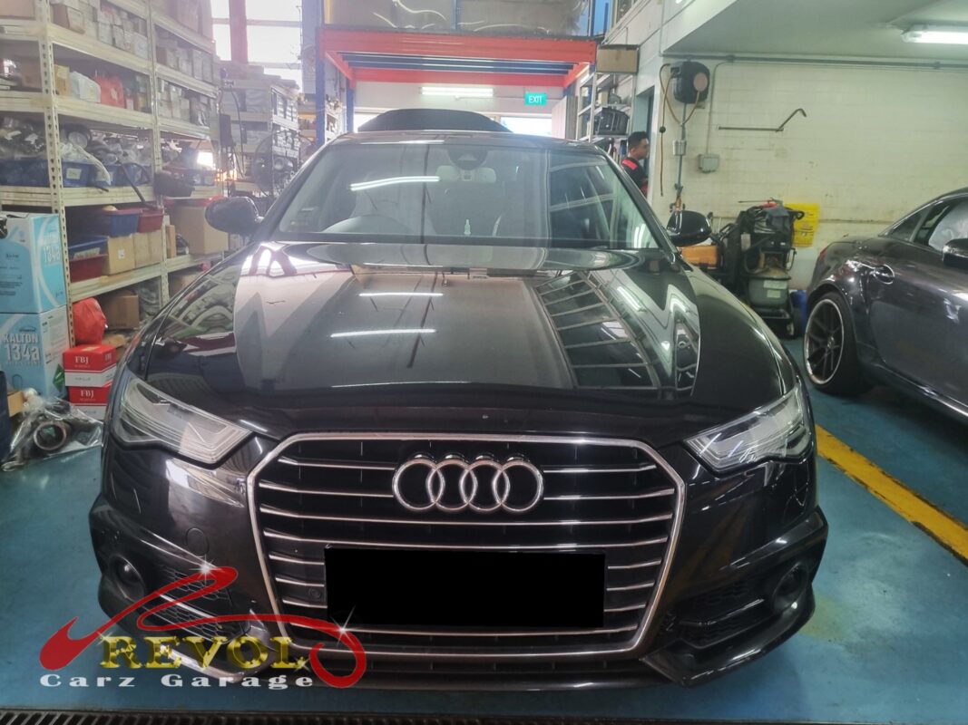 Audi A6 on the workshop lift for water pump replacement.
