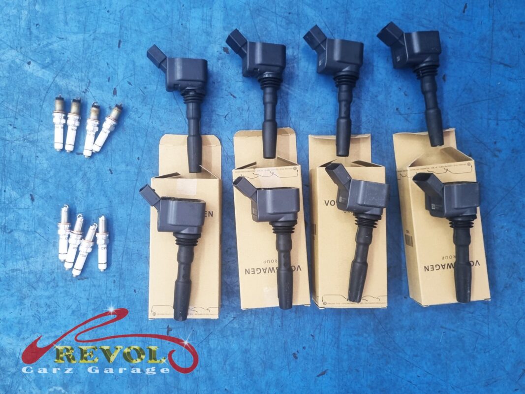 A fresh set of genuine VAG ignition coils and spark plugs, ready to go in. With misfires logged across several cylinders, the whole set was replaced rather than one at a time.