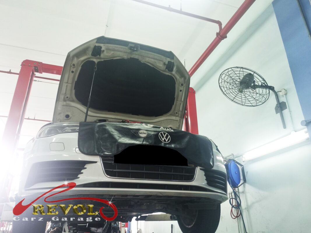 The Audi A3 up on the two-post lift, a fender cover draped over the front, ready for the water pump job.