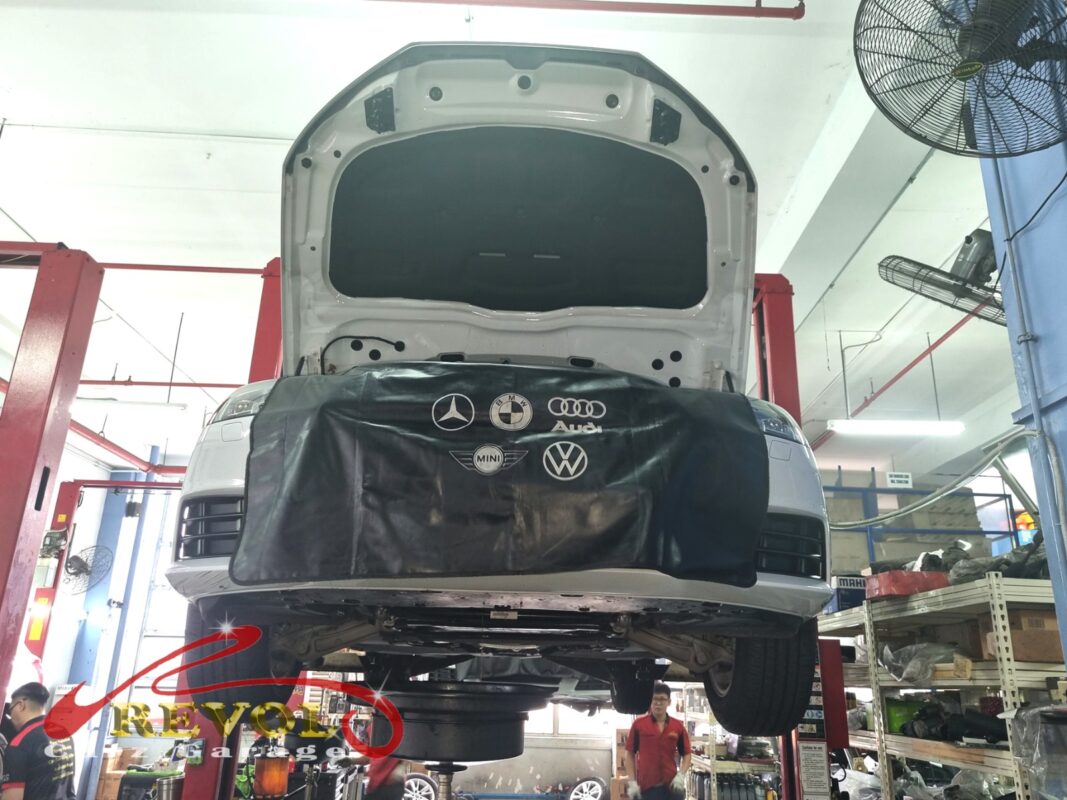 The Audi A4 up on the two-post lift, fender cover on, ready for the front suspension work.