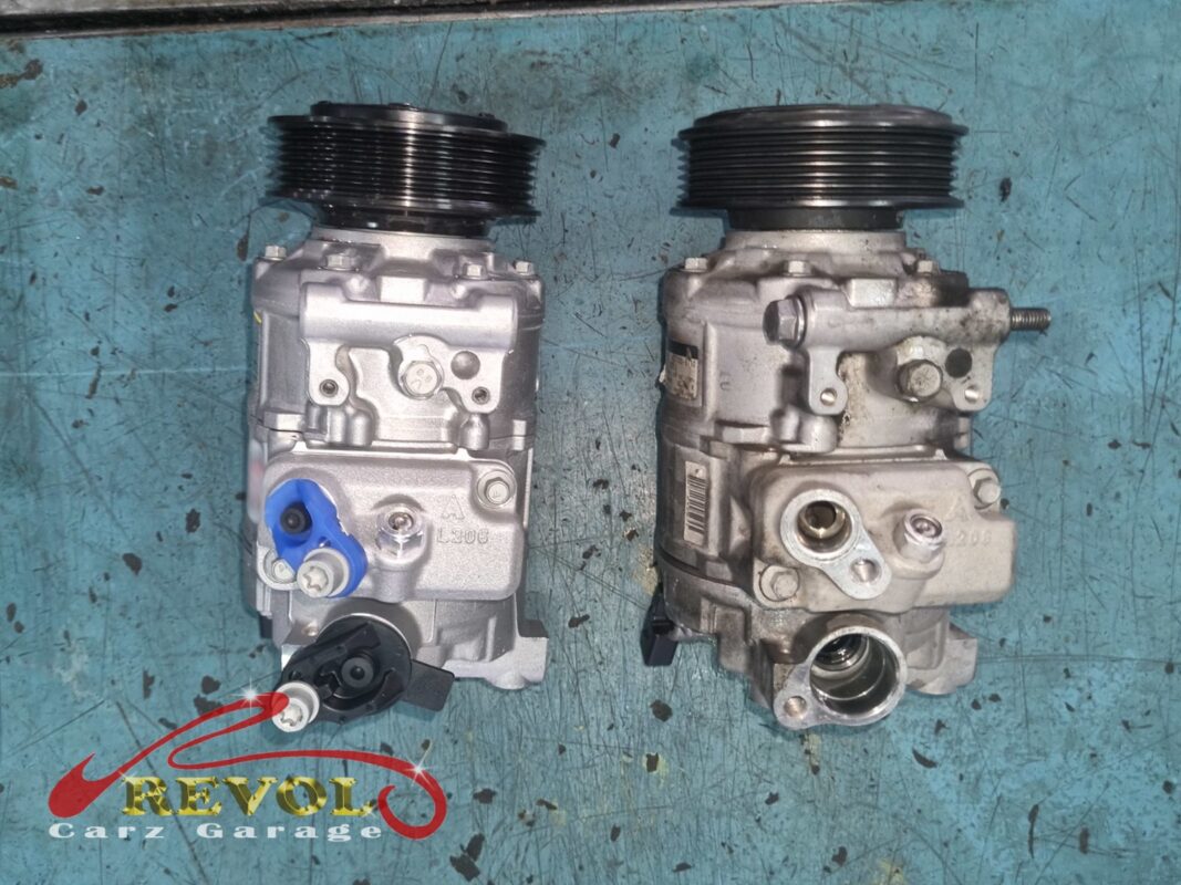 The old AC compressor (right) next to the new Audi-spec replacement (left, ports still capped). A worn clutch and rattling bearings meant the whole unit got swapped.