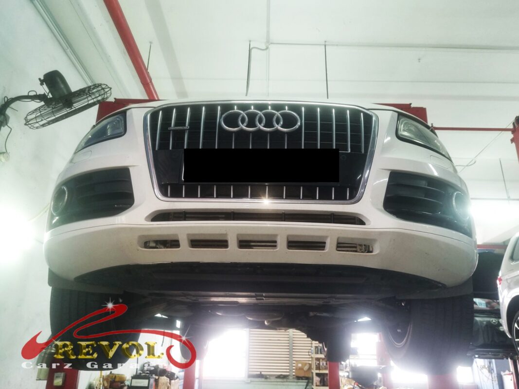 The Audi Q5 up on the two-post lift, front end raised for the suspension work.