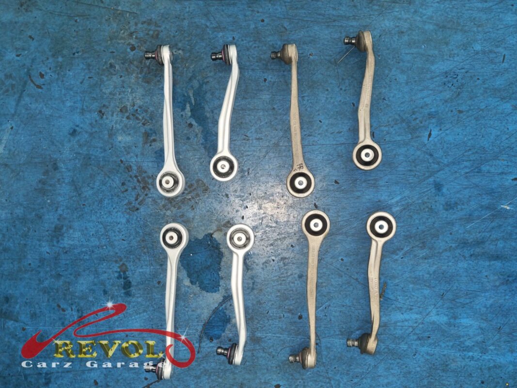 The full set of new Audi-spec front control arms before fitting. On this multilink front end the arms wear together, so all of them went in rather than just the worst pair.