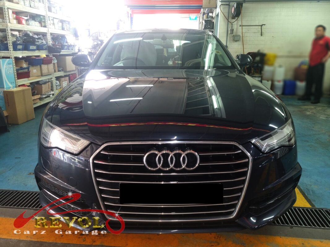 Audi A4 with the front of the engine open for timing cover repair.