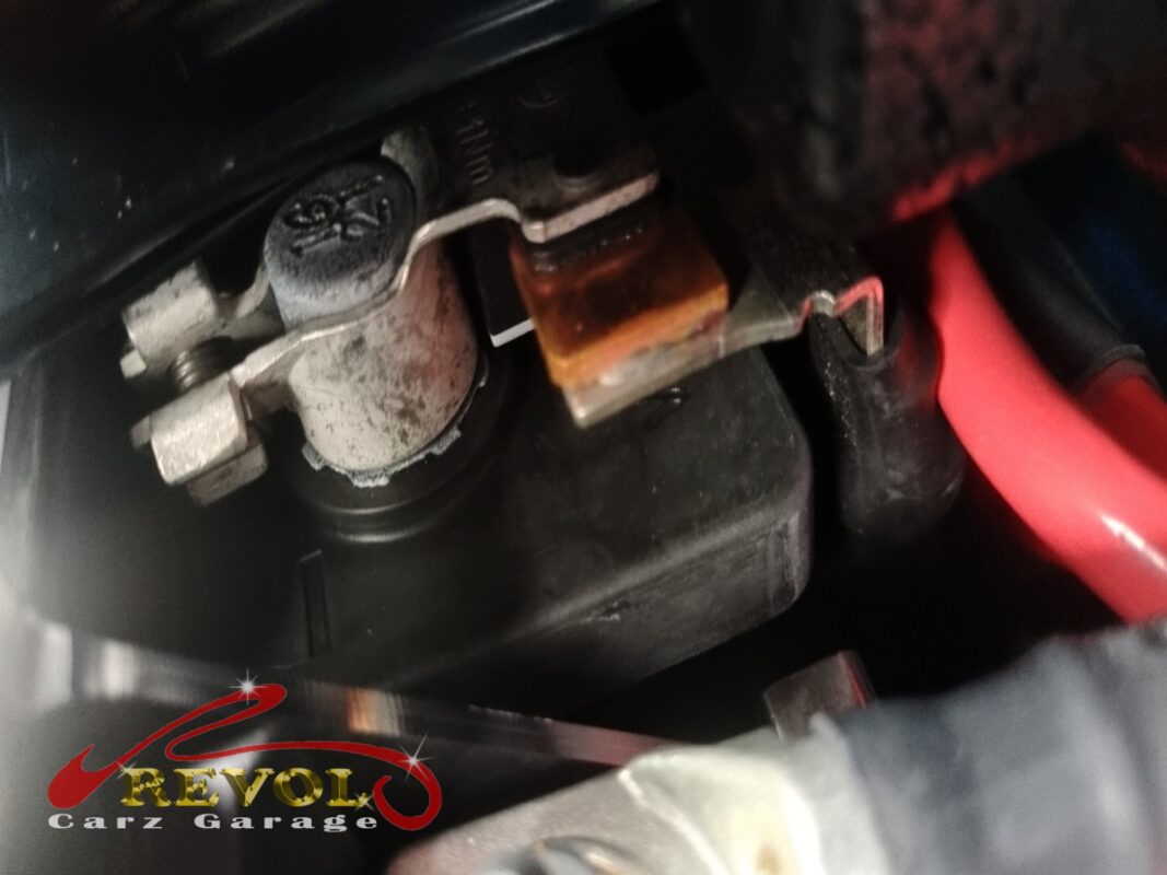 The battery terminals on the way in, corrosion building at the contact faces. One of the things a proper service catches.