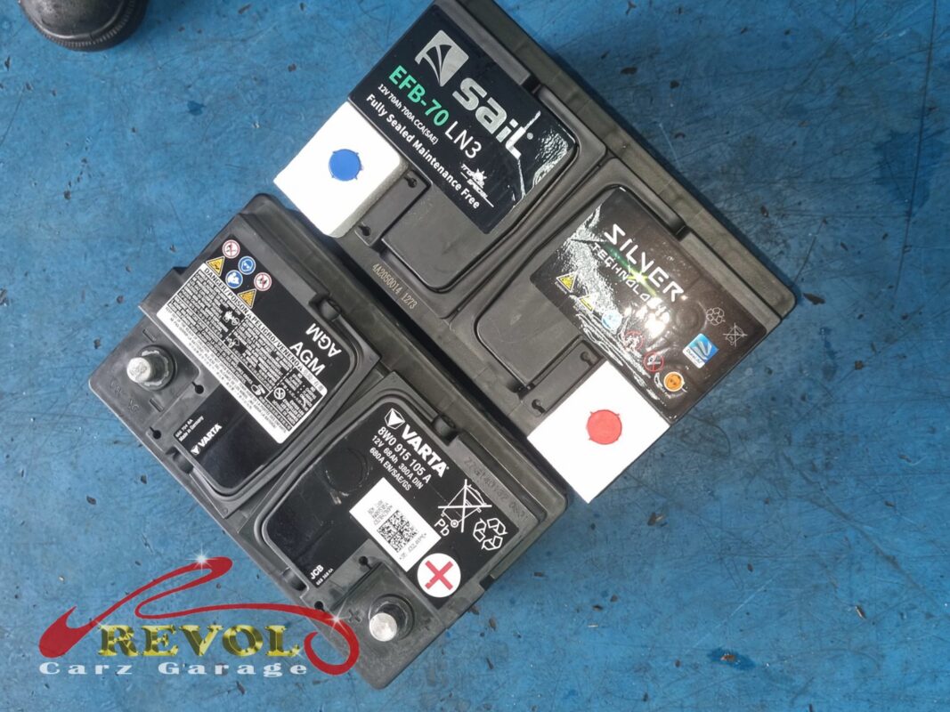 Batteries on the bench during the service, including the new AGM unit that went in to replace the original at end of life.
