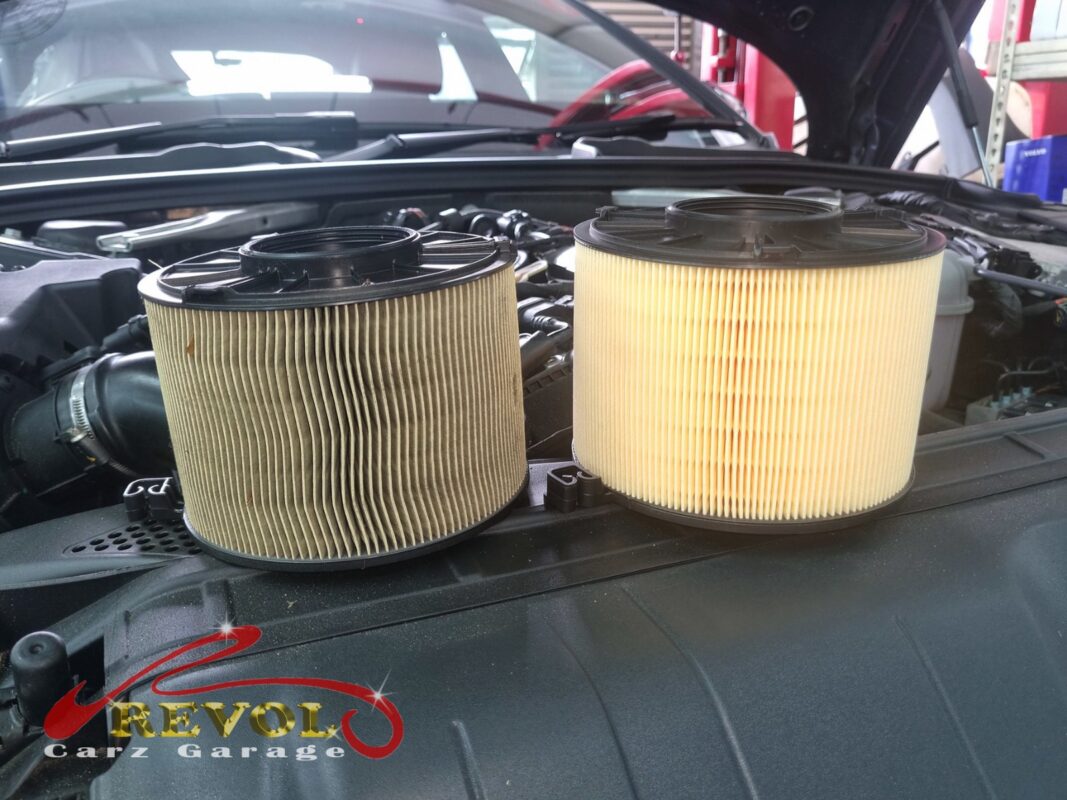 The old air filter (left, grimy) next to the fresh one (right) that went in as part of the service.