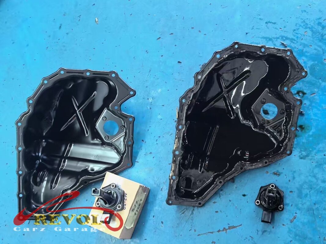The old oil sump pan (left) next to the new VAG-spec replacement (right), with the oil level sensor being carried over.