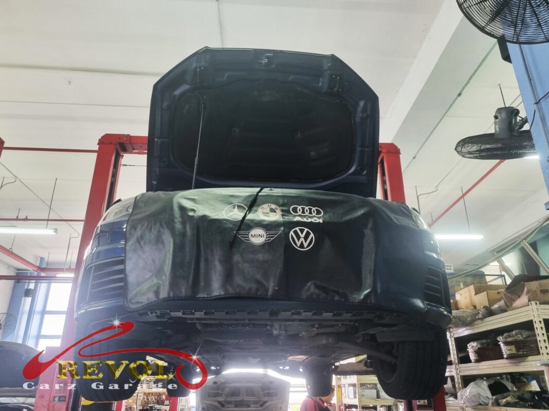 The Audi A3 up on the two-post lift, fender cover on, ready for the front subframe work.
