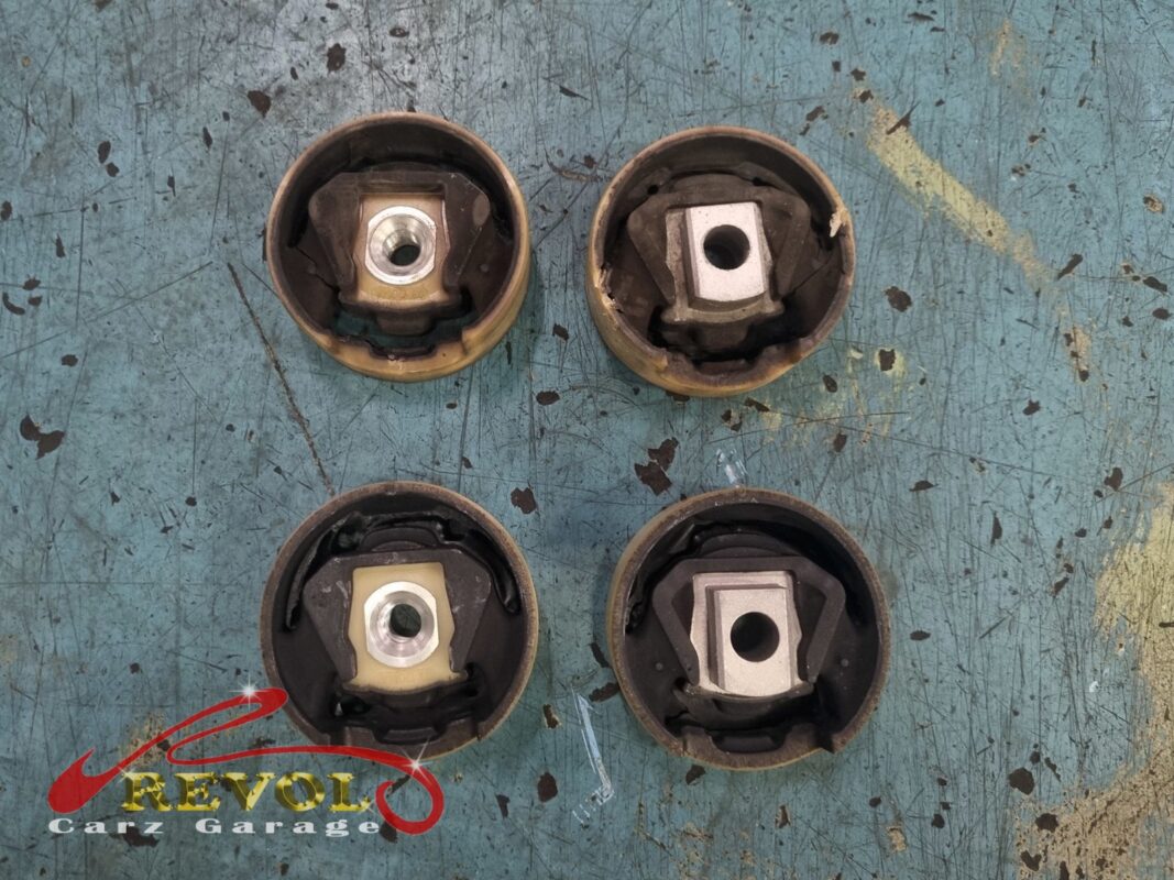 The four old subframe bushings pressed out, the rubber tired and starting to separate from the inner sleeve.