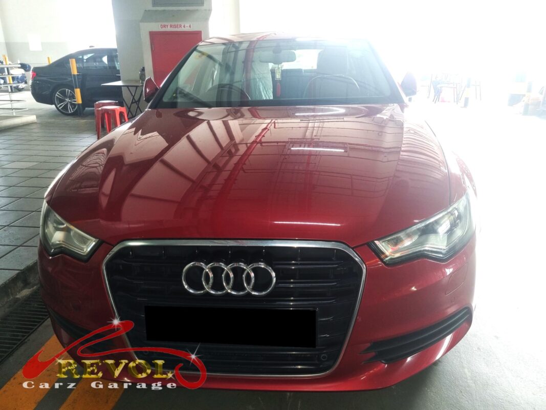 Audi A6 on the workshop lift for fan belt set replacement.