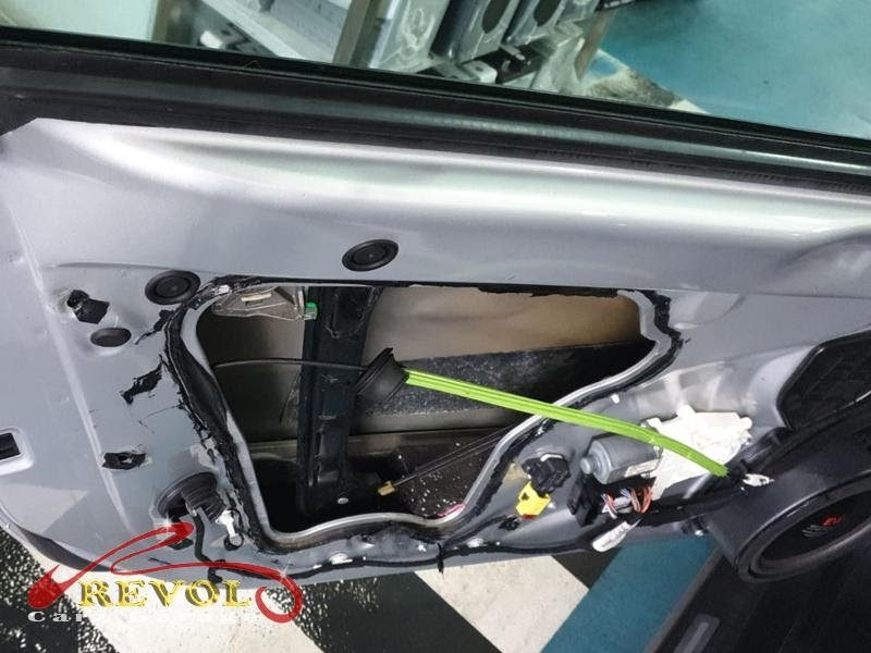 The passenger door card removed on the Audi to reach the lock.