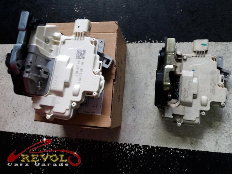 The worn door lock actuator removed from the door.