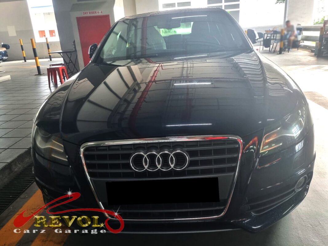 Audi A4 with the engine cover off and intake manifold removed for inspection.