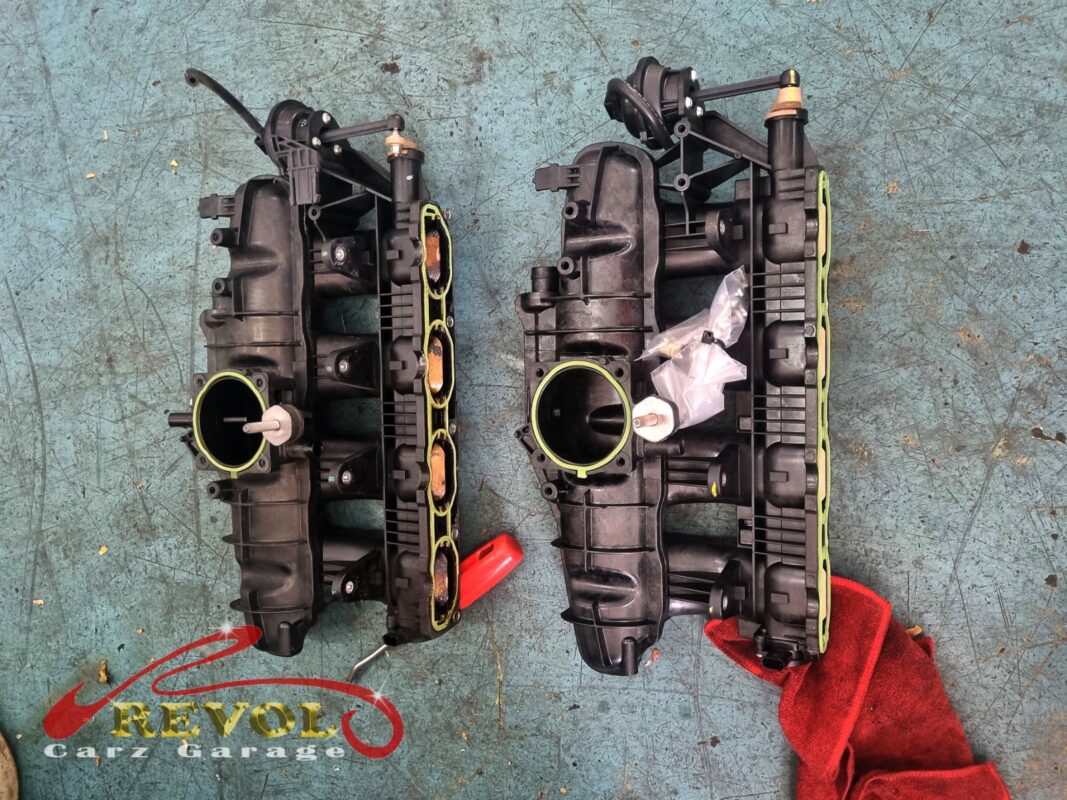 The old intake manifold (left) next to the new VAG-spec replacement (right), with the new bolt kit alongside.