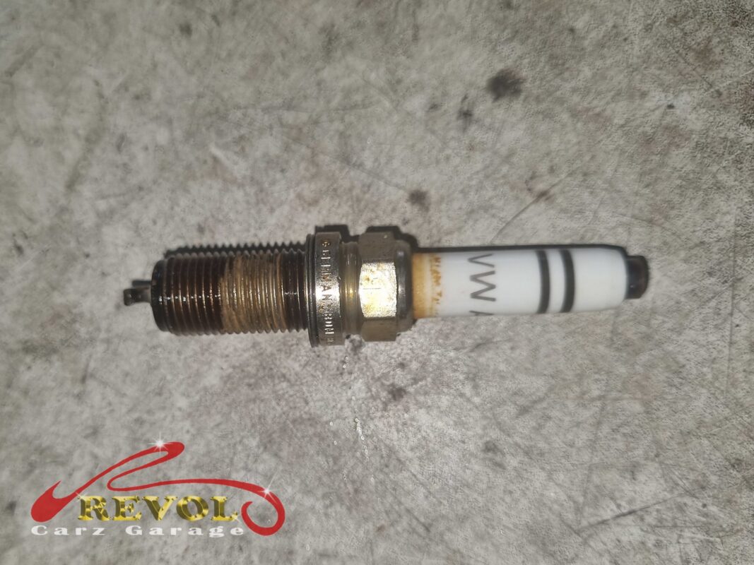 The spark plug from the misfiring cylinder, the threads discoloured and the electrode worn.