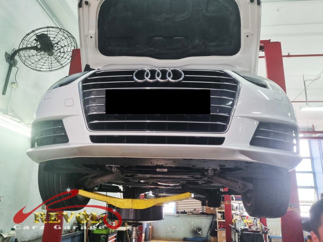 The white Audi A4 up on the two-post lift, in for the ATF pan job.