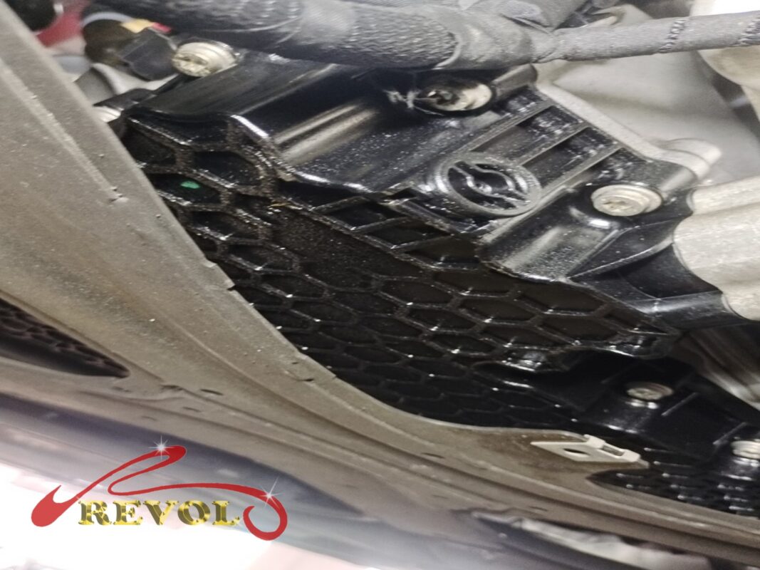 The transmission area from below, the ATF pan and the surrounding metal wet where the gasket had been weeping.