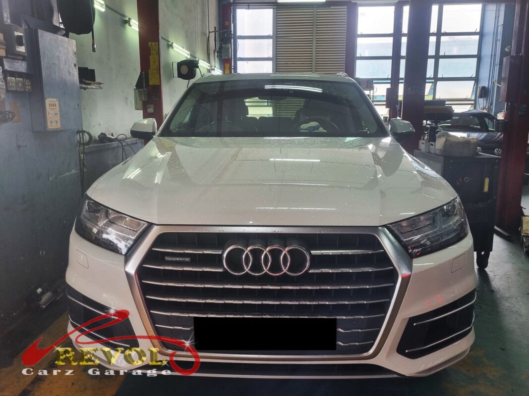 Audi Q7 with the engine bay open for coolant expansion tank replacement.