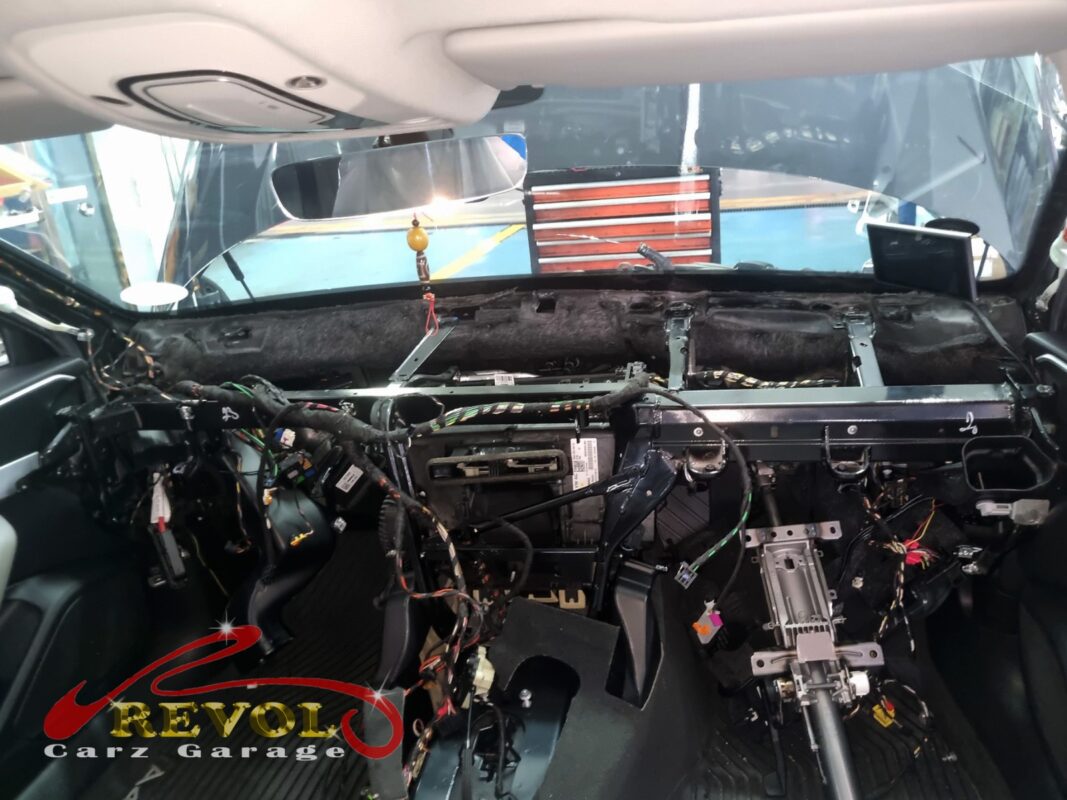 The A4's entire dashboard out, the bare bulkhead and HVAC box exposed. That is what it takes to reach the evaporator core.