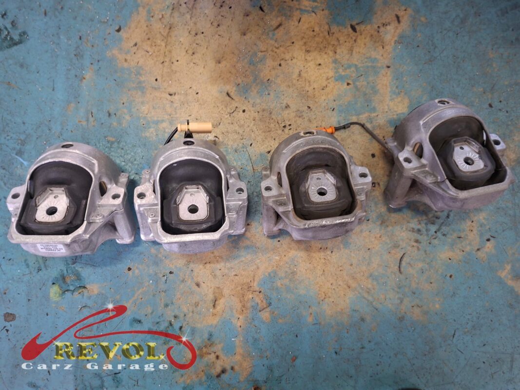The four old mounts off the car. The two with wiring are the electronically controlled engine mounts; the others the gearbox and torque mounts.